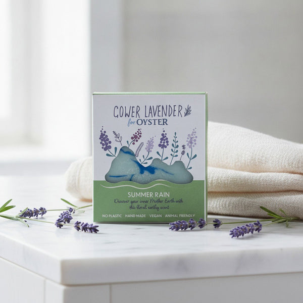 Gower Lavender Summer Rain handmade soap, boxed, on a white marble bathroom vanity with fresh lavender