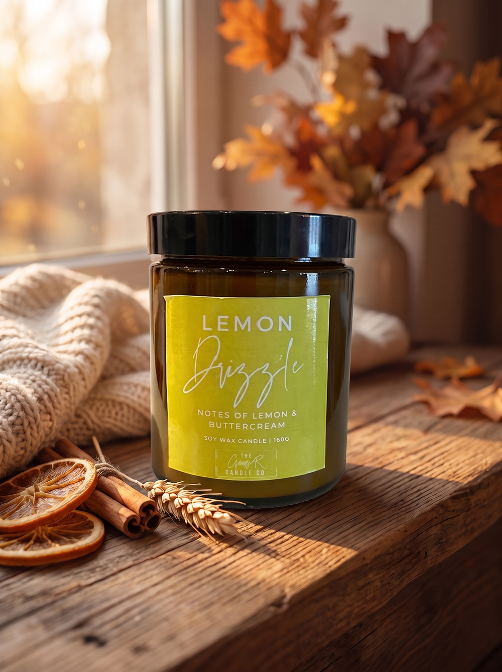 Lemon Drizzle candle styled in a cosy autumn window scene