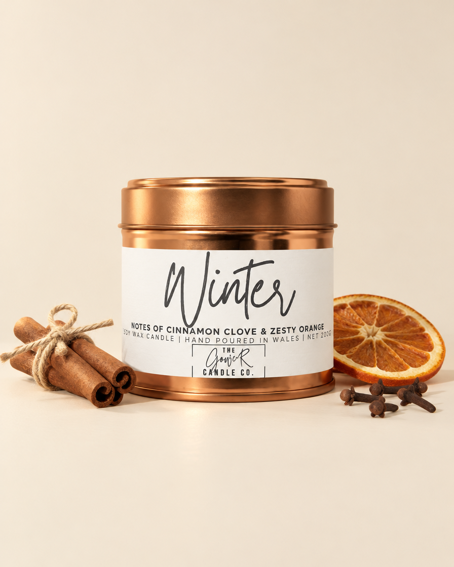 Winter rose gold soy candle by The Gower Candle Co. with cinnamon sticks, cloves and dried orange
