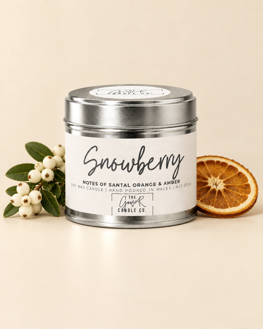 Snowberry silver soy candle by The Gower Candle Co. with white snowberries and a dried orange slice