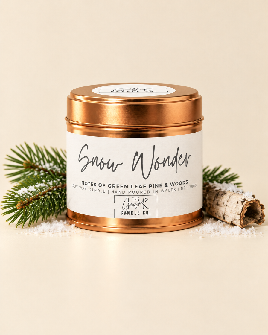 Snow Wonder rose gold soy candle by The Gower Candle Co. with pine sprig and birch bark