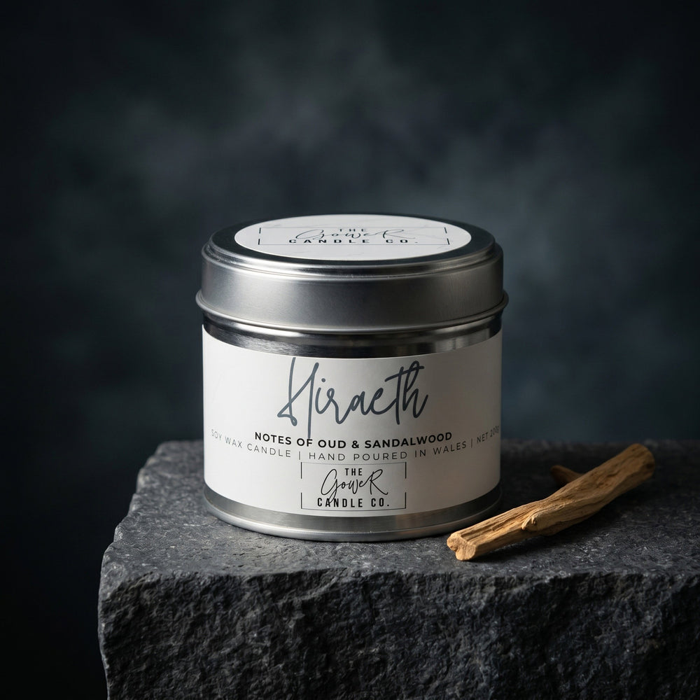 Hiraeth soy candle in a brushed tin with notes of oud and sandalwood, hand-poured in Wales by The Gower Candle Co.