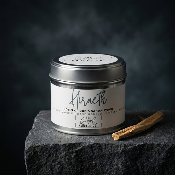 Hiraeth soy candle in a brushed tin with notes of oud and sandalwood, hand-poured in Wales by The Gower Candle Co.