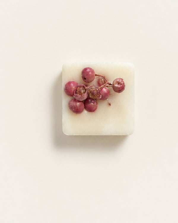 Winter Berry botanical soy wax melt topped with dried pink peppercorns