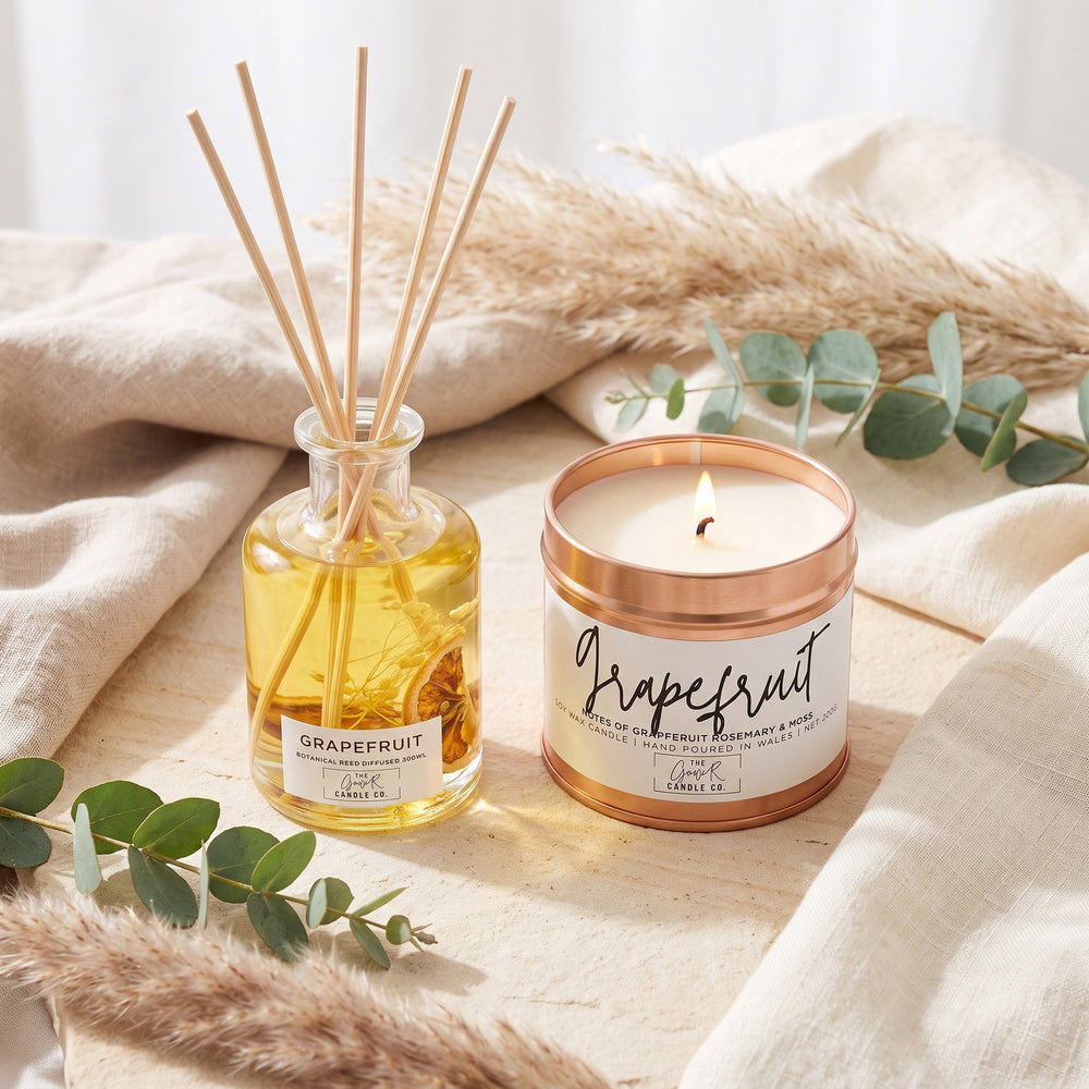 Grapefruit botanical reed diffuser and matching rose gold soy candle bundle by The Gower Candle Co., styled with pampas grass and eucalyptus