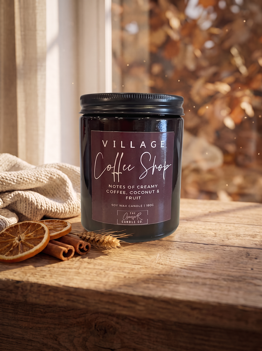 Village Coffee Shop candle styled in a cosy autumn window scene