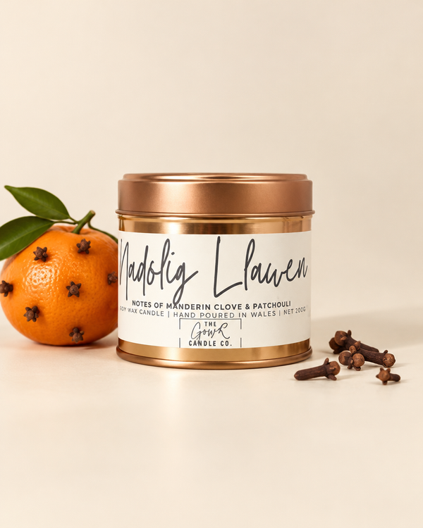 Nadolig Llawen rose gold soy candle by The Gower Candle Co. with a clove-studded mandarin